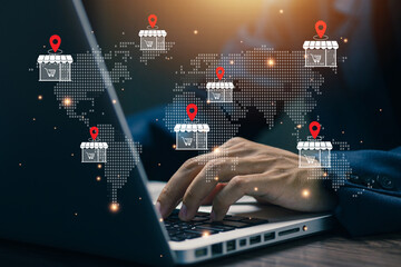 Businessman working on laptop with global store location icons, representing international e-commerce, global retail network, online business expansion, and digital marketplace strategy.