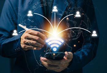 Businessman using smartphone with global wireless connection icons, representing digital communication, mobile connectivity, global network, online collaboration, and smart communication technology.