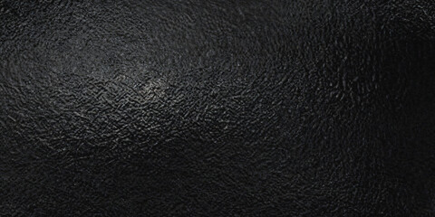 A deeply textured black background showcasing a rough surface with subtle variations in tone and shading displaying a dark aesthetic