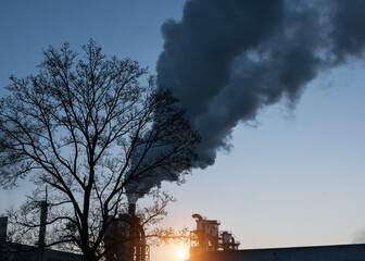 industrial smoke from chimney on blue sky