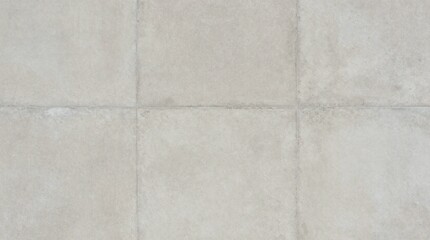 Fototapeta premium A close-up view of a tiled floor with a subtle texture and light gray grout lines