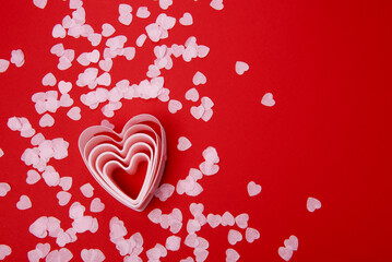 Beautiful and romantic valentines background with present and hearts in red for valentines day or anniversary holiday celebration with copy space