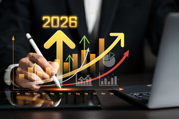 Business growth and financial success concept for 2026, showing upward graphs, monthly performance chart, and businessman using digital representing analytics, investment trends, market forecasting.