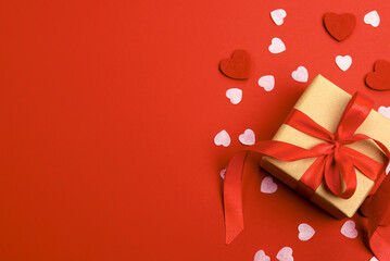 Beautiful and romantic valentines background with present and hearts in red for valentines day or anniversary holiday celebration with copy space