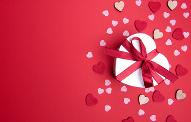 Beautiful and romantic valentines background with present and hearts in red for valentines day or anniversary holiday celebration with copy space