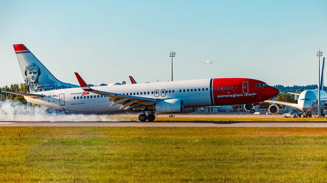 SE-RRJ Norwegian Air Sweden AOC Boeing 737-800 passenger jet airplane touchdown with smoking tires and a special livery on a sunny summer day at Munich airport, MUC, Freising, Bavaria, Germany