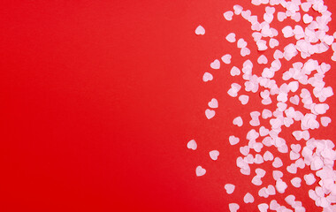 Beautiful and romantic valentines background with present and hearts in red for valentines day or anniversary holiday celebration with copy space