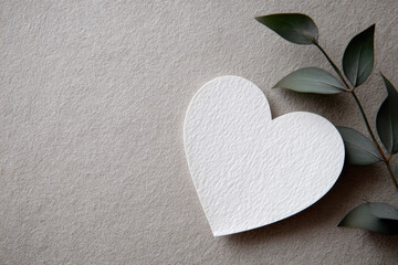 White heart paper textured cardstock botanical leaf neutral background minimalist design eco friendly craft concept love symbol flat lay soft light
