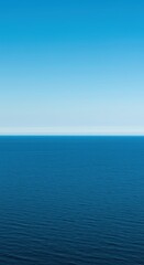 Fototapeta premium A vast, tranquil ocean panorama where the deep blue water meets the endless clear sky along a sharply defined, remote horizon line ,horizon ,seascape ,minimalist