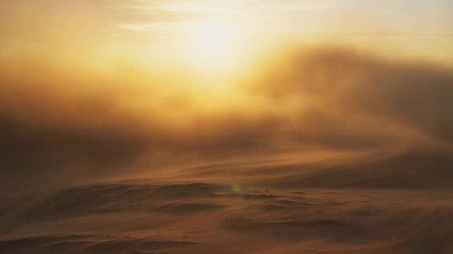 Dramatic sunrise over desert dunes with rolling sand and vibrant sky