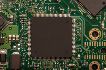 a modern printed circuit board with different tracks and chips and a central processor