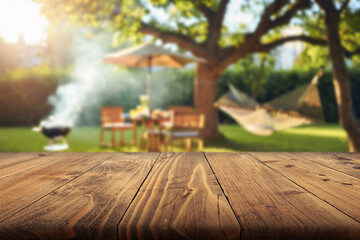 summer time in backyard garden with grill BBQ, wooden table, blurred background © Agil