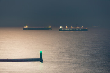 Freight ships anchored near Gdynia port in Puck Bay at moonlight