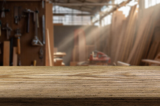 Sunlight streams through a window, casting warm rays onto a polished wooden workbench. The workshop is filled with various tools and equipment, creating a productive atmosphere.