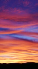 Fototapeta premium panoramic. A vibrant sunset over an open field, blending warm orange and purple hues across a panoramic sky. inspiring travel planning. 