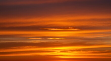 Obraz premium Vibrant orange sunset illuminating wispy clouds high above the horizon, creating a warm, dramatic atmospheric display ,outdoor ,peaceful ,freedom