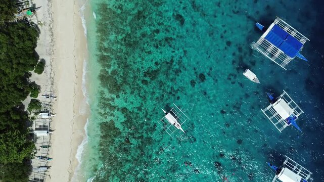 Aerial top view of beautiful tropical beach with white sand and boats in sea, Philippines, 4k