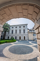 Obraz premium Archway View Of Historic Courtyard With Cobblestone Spiral Pattern, Palazzo Borromeo on Isola Bella, Lake Maggiore, Italy