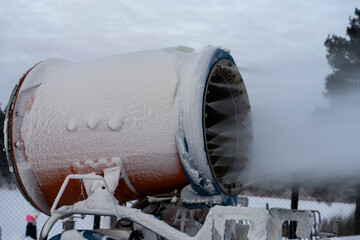 Snow cannon. A snow making machine on the ski slope to prepare the ski resort for the next day. The winter sports industry.