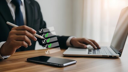 Businessman analyzing data on laptop and smartphone with stylus in office environment