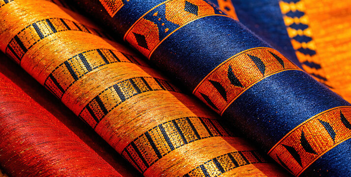 Vibrant African Textiles with Traditional Patterns and Colors Rolled Up - Powered by Adobe