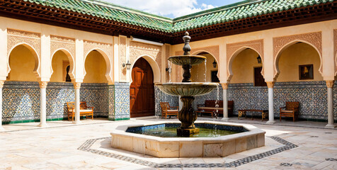 Traditional Moroccan Courtyard with Ornate Fountain and Arches