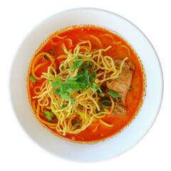 Thai chicken yellow noodle soup in white bowl isolated on white.