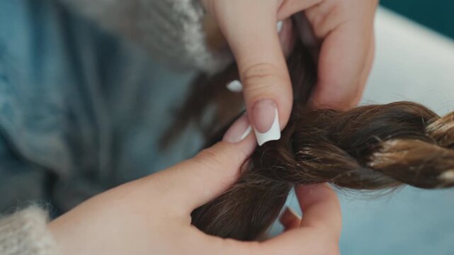 Caucasian Hands Adding Finishing Touch To Braid Stylist With French Manicure Tightening Plait, Focused Closeup, Glossy Nails, Careful Weaving, Studio Light Highlighting Texture And Knot Detail