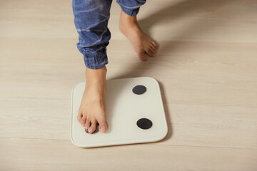 Feet of man on weighting scale - weight loss concept