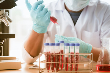 Scientist using medical tool for extraction of liquid from samples in special laboratory or medical room