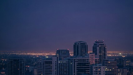 Cityscape at dusk with modern skyscrapers and urban lights with copy space