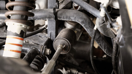 Old car suspensions. Close up car suspension wear and tear parts. CV joint Rubber boot and Control arms bushing Steering rack axles Shock absorber Brake exhaust. Gas Diesel car service repair parts.