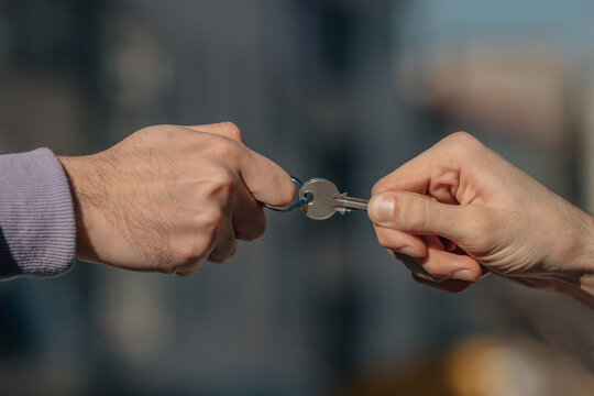 two hands pulling on the house key