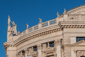 Architectural details of historic Vienna Burgtheater (Imperial Court Theatre) or “K.K. Hofburgtheater”, 1888. Sunset. VIENNA, AUSTRIA.