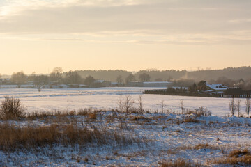 Naklejka premium Snow covered field. Winter landscape in northern Poland. Europe