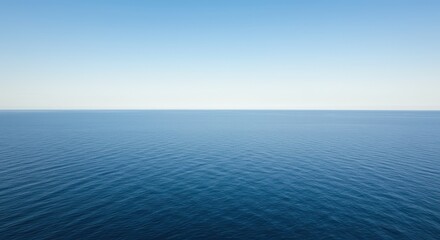 A vast and tranquil scene showing the boundary between the deep blue ocean water and the bright, clear morning sky above the distant curve, curvature, morning, expansive