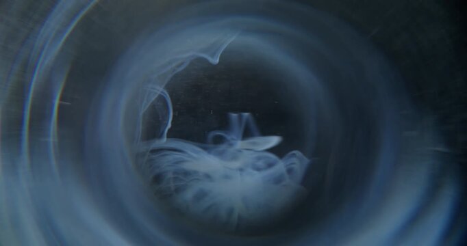 Wave fog blur. Water ink. Blue gray circle prism swirling splash. Dark color haze dye drop mixing in liquid abstract black background.