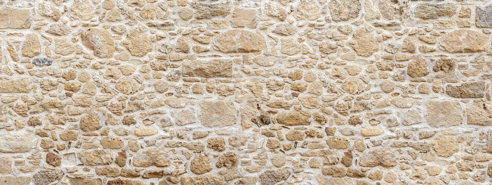 Old stone wall texture background showing masonry construction