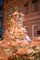 A beautiful Christmas tree covered with snow outside in winter