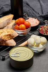 Set of ingredients for preparing tuna appetizer on a black background