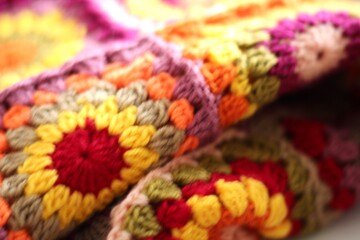 Granny square crocheted blanket with different colors motives, retro vintage craft handmade handiwork crocheting, beautiful plaid photo cozy winter or autumn background wool thing yarn warm bohemian 