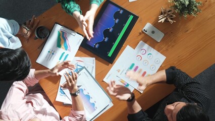 Top down view of business woman explain and present financial chart. Group discuss and listen presentation about stock market statistic at meeting table with investment graph. Time lapse. Convocation.
