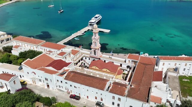 Aerial drone cinematic video of iconic bay and Monastery of Archangel Michael Panormitis, Symi island, Dodecanese, Greece
