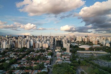 City skyline of Sao Paulo with clouds and greenery in the foreground