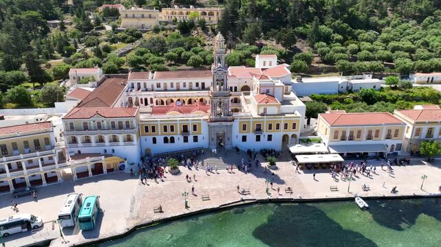 Aerial drone cinematic video of iconic bay and Monastery of Archangel Michael Panormitis, Symi island, Dodecanese, Greece