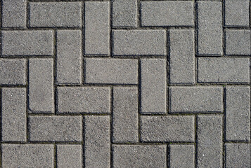 Gray traatuarnvya tiles laid in a herringbone pattern. Large plan.