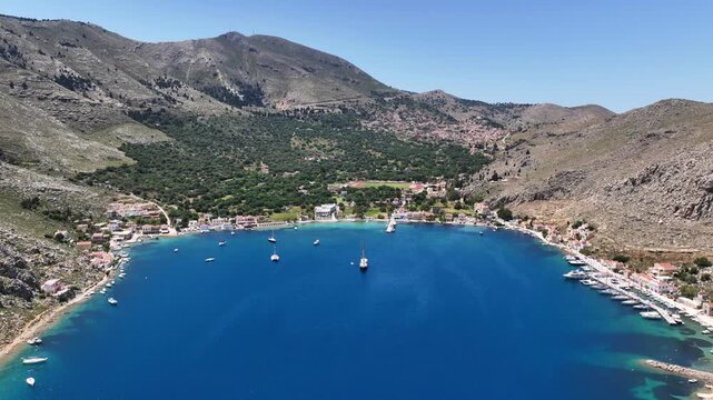 Aerial drone cinematic video of picturesque fjord shaped bay of Pedi in island of Symi, Dodecanese, Greece