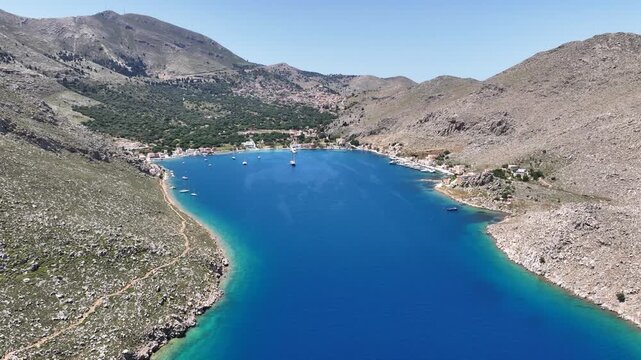 Aerial drone cinematic video of picturesque fjord shaped bay of Pedi in island of Symi, Dodecanese, Greece