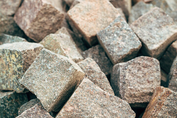 Granite cobblestone paver stone in various earthy tones at an outdoor storage yard