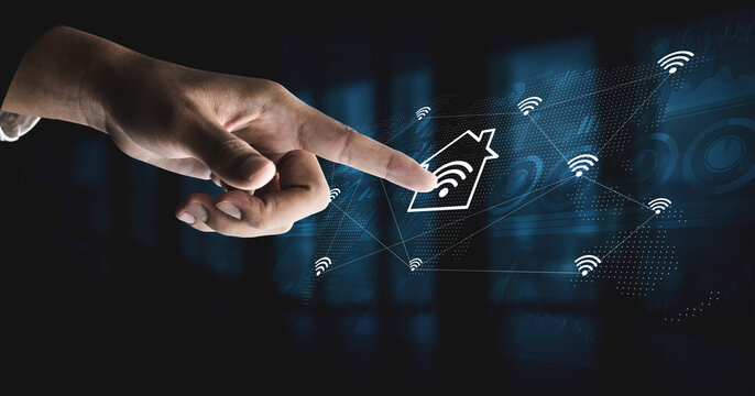 A hand points at a smart home icon surrounded by Wi-Fi signals, symbolizing digital connectivity and advancement in technology. Perfect for illustrating innovation. Gantry - Powered by Adobe